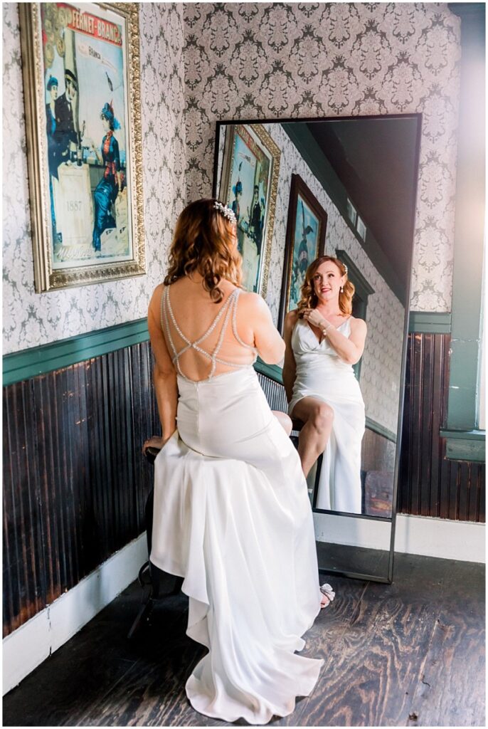 bride in front of mirror in vintage room