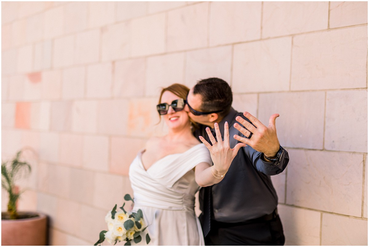 cool bride and groom in sunglasses showing off their rings at Thousand Oaks Civic Center